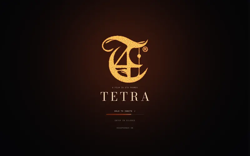 The title card: the T monogram glowing over the dark, “Hold to ignite” beneath it